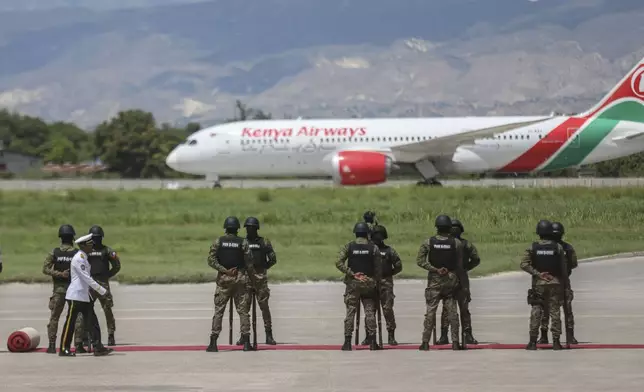 Kenyan police, part of a UN-backed multinational force, receive the plane transporting Kenya's President William Ruto, at their base in Port-au-Prince, Haiti, Saturday, Sept. 21, 2024. (AP Photo/Odelyn Joseph)