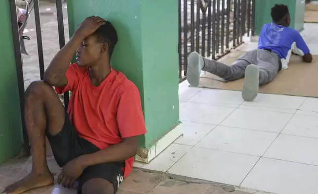 Relatives of people injured during armed gang attacks wait around at Saint Nicolas hospital in Saint-Marc, Haiti, Sunday, Oct. 6, 2024. (AP Photo/Odelyn Joseph)