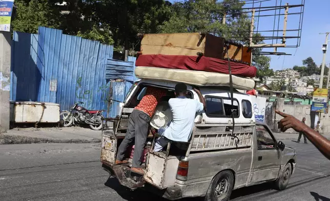 A residents flee their home escaping gang violence in the Solino neighborhood of Port-au-Prince, Haiti, Saturday, Oct. 26, 2024. (AP Photo/Odelyn Joseph)
