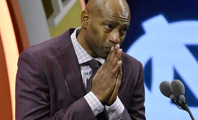 Vince Carter reacts while talking about his mother during his enshrinement in the Basketball Hall of Fame, Sunday Oct. 13, 2024, in Springfield, Mass. (AP Photo/Jessica Hill)