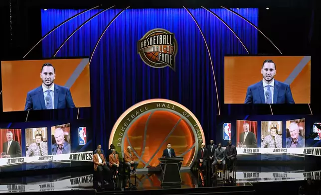 Jonnie West, center, speaks during his late father Jerry West's enshrinement in the Basketball Hall of Fame, Sunday Oct. 13, 2024, in Springfield, Mass. (AP Photo/Jessica Hill)