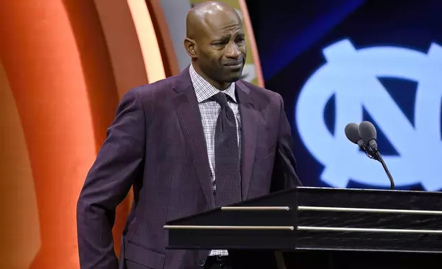 Vince Carter reacts while talking about his mother during his enshrinement in the Basketball Hall of Fame, Sunday Oct. 13, 2024, in Springfield, Mass. (AP Photo/Jessica Hill)