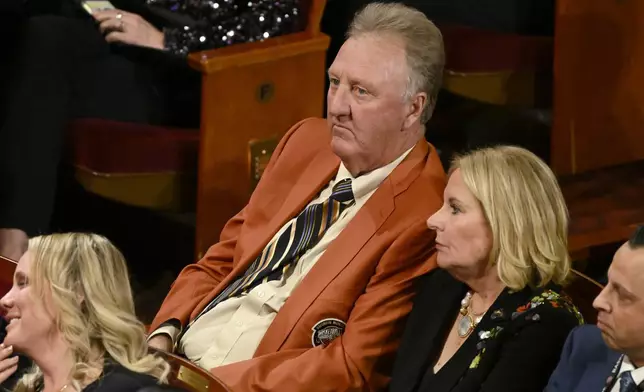 Larry Bird, top, sits in the audience during the Basketball Hall of Fame enshrinement ceremony, Sunday Oct. 13, 2024, in Springfield, Mass. (AP Photo/Jessica Hill)