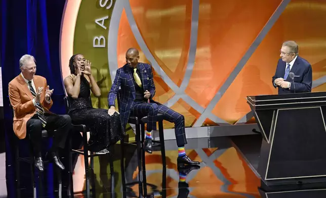 Tamika Catchings, second from left, yells out as Larry Bird, left, Reggie Miller and Herb Simon, right, look on during Simon's enshrinement at the Basketball Hall of Fame, Sunday Oct. 13, 2024, in Springfield, Mass. (AP Photo/Jessica Hill)