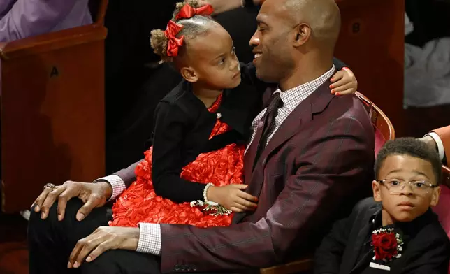 Vince Carter sits with his children prior to his enshrinement in the Basketball Hall of Fame, Sunday Oct. 13, 2024, in Springfield, Mass. (AP Photo/Jessica Hill)