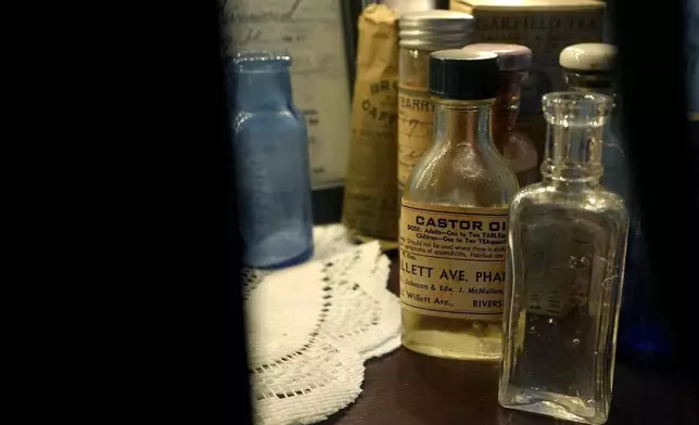 Old-fashioned medicine bottles rest on a shelf in an exhibit at the Lizzie Borden House, site of an 1892 double axe murder, Wednesday, Oct. 16, 2024, in Fall River, Mass. (AP Photo/Steven Senne)