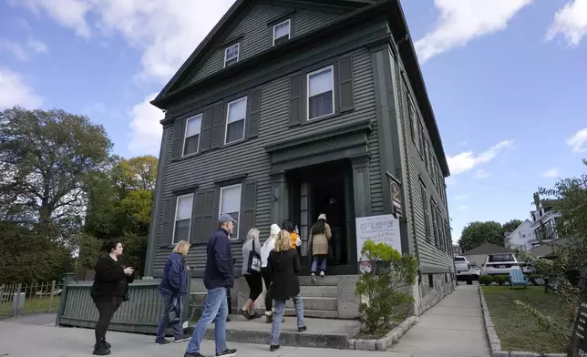 Visitors enter the Lizzie Borden House, site of an 1892 double axe murder, Wednesday, Oct. 16, 2024, in Fall River, Mass. (AP Photo/Steven Senne)