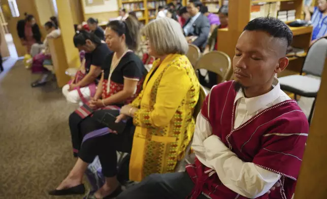 Parishioners pray during a Karen-language service at Indian Lake Baptist Church, while celebrating 15 years of partnership with the 150-year-old congregation founded by Swedish immigrants, in Worthington, Minn., on Sunday Oct. 20, 2024. (AP Photo/Jessie Wardarski)