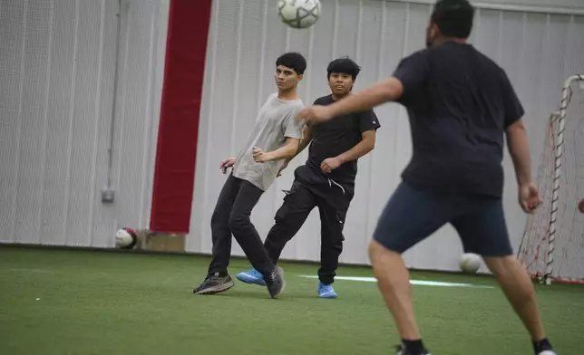 Community members play a game of soccer in the JBS Fieldhouse in Worthington, Minn., on Monday, Oct. 21, 2024. (AP Photo/Jessie Wardarski)