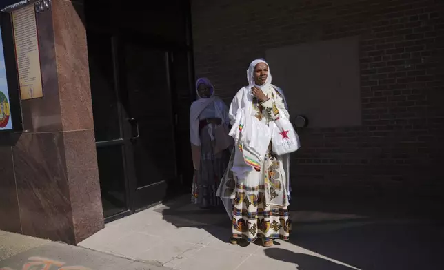 Women stand outside of the Ethiopian Orthodox Tewahedo Church after service on Sunday, Oct. 20, 2024, in Worthington, Minn. (AP Photo/Jessie Wardarski)