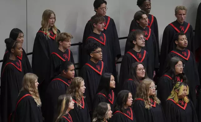 High school students perform in a choir concert at Worthington High School, in Worthington, Minn., on Monday, Oct. 21, 2024. (AP Photo/Jessie Wardarski)