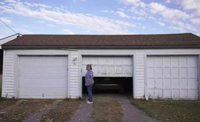 Julie Robinson opens her garage on property her family has owned for 132 years, in Worthington, Minn., on Monday, Oct. 21, 2024. (AP Photo/Jessie Wardarski)