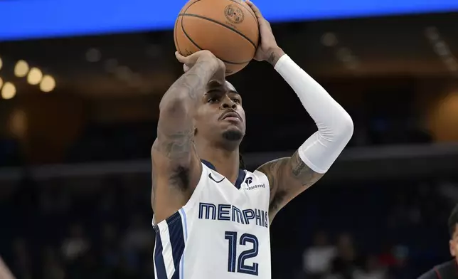 Memphis Grizzlies guard Ja Morant prepares to shoot a free throw in the first half of an NBA preseason basketball game against the Miami Heat, Friday, Oct. 18, 2024, in Memphis, Tenn. (AP Photo/Brandon Dill)
