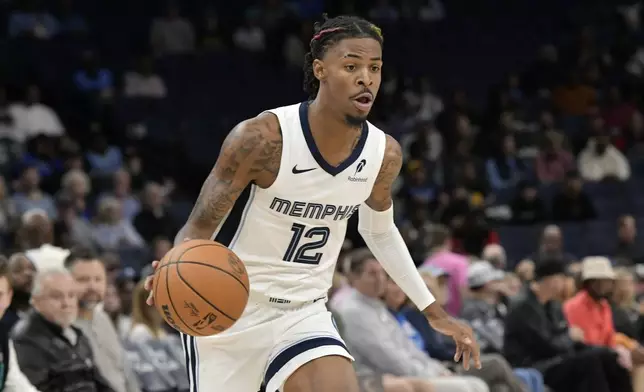 Memphis Grizzlies guard Ja Morant handles the ball against the Miami Heat in the first half of an NBA preseason basketball game Friday, Oct. 18, 2024, in Memphis, Tenn. (AP Photo/Brandon Dill)