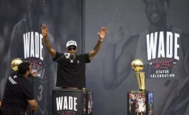 Former Miami Heat NBA basketball player Udonis Haslem, second from left, speaks during a statue unveiling ceremony for former teammate Dwyane Wade outside the Kaseya Center, Sunday, Oct. 27, 2024, in Miami, Fla. (AP Photo/Michael Laughlin)