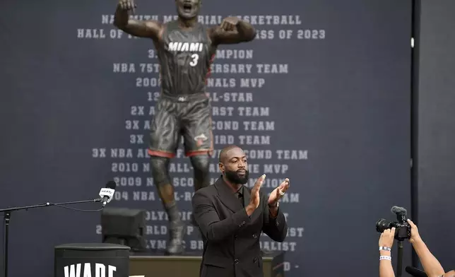 Former Miami Heat NBA basketball player Dwyane Wade thanks the crowd during his statue unveiling ceremony outside Kaseya Center, Sunday, Oct. 27, 2024, in Miami, Fla. (AP Photo/Michael Laughlin)