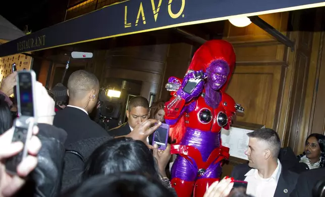 FILE - Heidi Klum, dressed in an eight-foot-tall "Transformer" costume, arrives to her Halloween Party in New York, Sunday, Oct. 31, 2010. (AP Photo/Charles Sykes, File)
