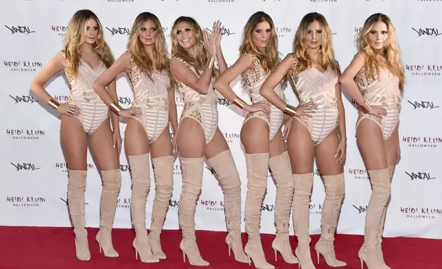 FILE - Heidi Klum, third from left, poses with "Heidi Clones" at her 17th Annual Halloween Party at Vandal on Monday, Oct. 31, 2016, in New York. (Photo by Evan Agostini/Invision/AP, File)