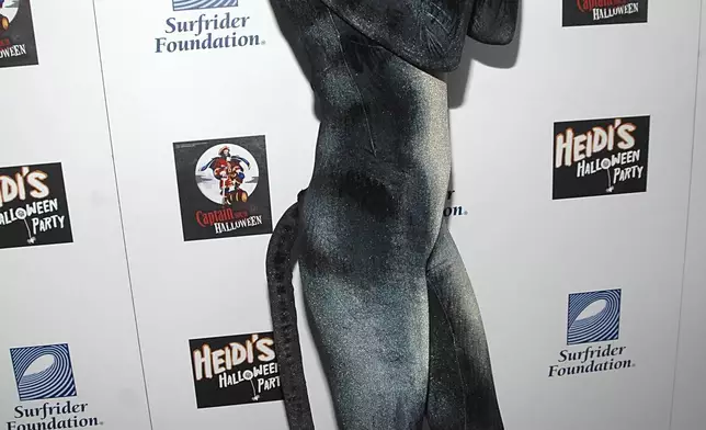 FILE - Heidi Klum, dressed as a cat, poses on the press line at "Heidi's Halloween Party" in Los Angeles on Wednesday, Oct. 31, 2007. (AP Photo/Dan Steinberg, File)