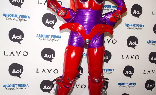 FILE - Heidi Klum, dressed in an eight-foot-tall "Transformer" costume, arrives at her Halloween Party in New York, Sunday, Oct. 31, 2010. (AP Photo/Charles Sykes, File)
