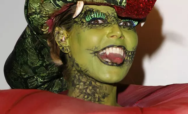 FILE - Heidi Klum, dressed as the forbidden fruit, arrives at her 7th Annual Halloween Party held at SBE's Privilege nightclub in Los Angeles on Tuesday, October 31, 2006. (AP Photo/Chris Polk, File)