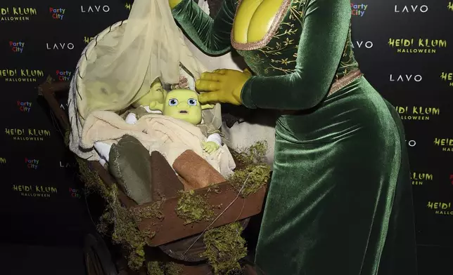 FILE - Heidi Klum, right, dressed as Princess Fiona and Tom Kaulitz dressed as Shrek arrive at Klum's 19th annual Halloween party at Lavo New York on Wednesday, Oct. 31, 2018, in New York. (Photo by Evan Agostini/Invision/AP, File)