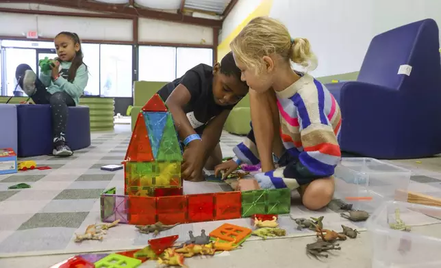 Children play games at the Project:Camp pop-up daycamp for families impacted by Hurricane Helene at the Boys and Girls Club of Transylvania County in Brevard, N.C., Monday, Oct. 7, 2024. (AP Photo/Gabriela Aoun Angueira)