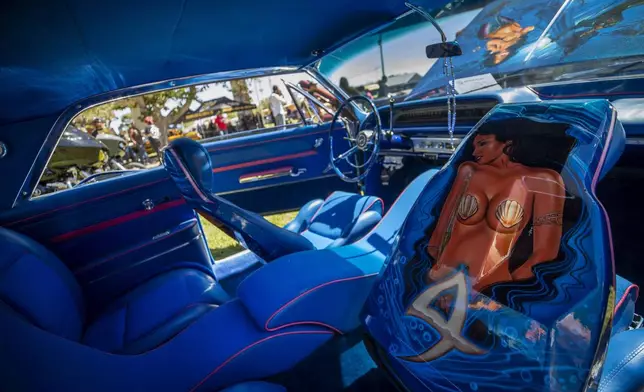 The decorated interior of a vintage car is pictured during a lowrider exhibition for the 20th anniversary of Lincoln Park in El Paso, Texas, Sunday, Sept. 22, 2024. (AP Photo/Andrés Leighton)