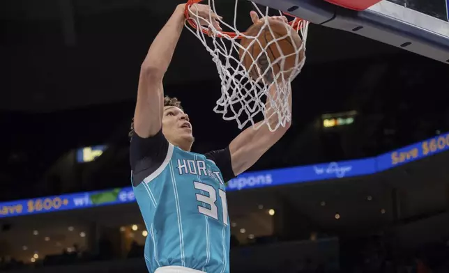 Charlotte Hornets' Tidjane Salaun (31), of France, dunks in the second half of a preseason NBA basketball game against the Memphis Grizlies, Thursday, Oct. 10, 2024, in Memphis, Tenn. (AP Photo/Nikki Boertman)