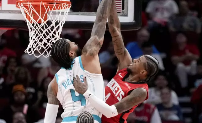 Charlotte Hornets center Nick Richards (4) blocks the shot of Houston Rockets guard Jalen Green during the first half of an NBA basketball game Wednesday, Oct. 23, 2024, in Houston. (AP Photo/Eric Christian Smith)