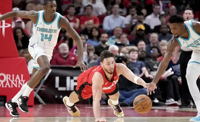 Houston Rockets center Alperen Sengun, center, Charlotte Hornets forward Moussa Diabate (14), and center Nick Richards, right, chase a loose ball during the first half of an NBA basketball game Wednesday, Oct. 23, 2024, in Houston. (AP Photo/Eric Christian Smith)