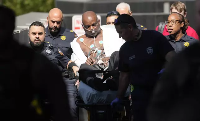 Former Houston police officer Gerald Goines is taking to an ambulance after having a medical emergency in the 482nd District Court at the Harris County Criminal courthouse during the punishment phase of his felony murder trial Thursday, Oct. 3, 2024, in Houston. (Melissa Phillip/Houston Chronicle via AP)