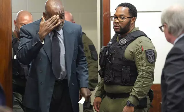 Former Houston police officer Gerald Goines is led back into the courtroom to be formally sentenced on a pair of felony murder convictions on Tuesday, Oct. 8, 2024, in Houston. Goines was found guilty of felony murder and sentenced to 60 years behind bars in the 2019 deaths of Dennis Tuttle and Rhogena Nicholas. (Brett Coomer/Houston Chronicle via AP)