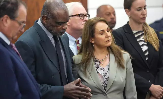 Former Houston police officer Gerald Goines stands with his lawyer, Nicole Deborde Hochglaube, and his defense team as the verdict sentencing him to 60 years behind bars on a pair of felony murder convictions on Tuesday, Oct. 8, 2024 in Houston. Goines was found guilty of felony murder in the 2019 deaths of Dennis Tuttle and Rhogena Nicholas. (Brett Coomer/Houston Chronicle via AP)