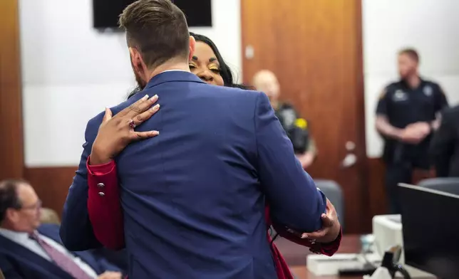 Prosecutors Keaton Forcht, left, and Tanisha Manning embrace just before former Houston police officer Gerald Goines was sentenced to 60 years behind bars on a pair of felony murder convictions on Tuesday, Oct. 8, 2024 in Houston. Goines was found guilty of felony murder in the 2019 deaths of Dennis Tuttle and Rhogena Nicholas. (Brett Coomer/Houston Chronicle via AP)