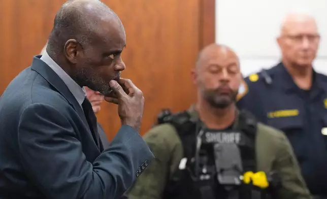 Former Houston Police officer Gerald Goines stands as he is formally sentenced on a pair of felony murder convictions on Tuesday, Oct. 8, 2024, in Houston. Goines was found guilty of felony murder and sentenced to 60 years behind bars in the 2019 deaths of Dennis Tuttle and Rhogena Nicholas. (Brett Coomer/Houston Chronicle via AP)