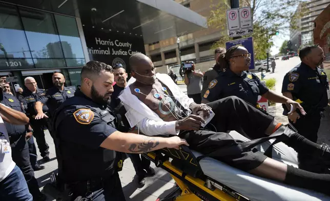 Former Houston police officer Gerald Goines is taking to an ambulance after having a medical emergency in the 482nd District Court at the Harris County Criminal courthouse during the punishment phase of his felony murder trial Thursday, Oct. 3, 2024, in Houston. (Melissa Phillip/Houston Chronicle via AP)