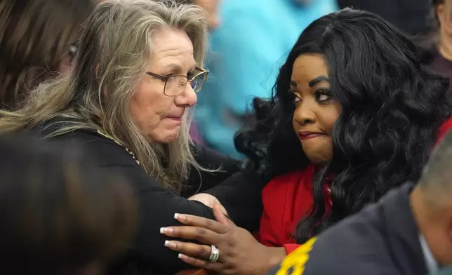 Elizabeth Ferrari, sister of Dennis Tuttle, left, talks to prosecutor Tanisha Manning, after former Houston police officer Gerald Goines was sentenced to 60 years behind bars on a pair of felony murder convictions on Tuesday, Oct. 8, 2024, in Houston. Goines was found guilty of felony murder in the 2019 deaths of Dennis Tuttle and Rhogena Nicholas. (Brett Coomer/Houston Chronicle via AP)