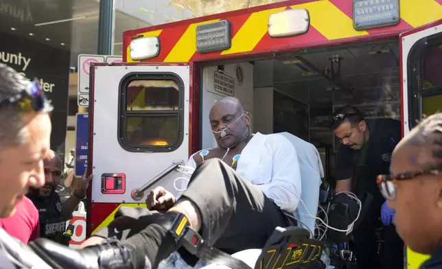 Former Houston police officer Gerald Goines is placed into ambulance after having a medical emergency during the punishment phase of his felony murder trial Thursday, Oct. 3, 2024, at the Harris County Criminal courthouse in Houston. (Melissa Phillip/Houston Chronicle via AP)/Houston Chronicle via AP)