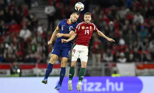 Stefan De Vrij of the Netherlands jumps for the ball with Hungary's Bendeguz Bolla, right, during the Nations League soccer match between Hungary and the Netherlands at the Puskas Arena in Budapest, Friday, Oct. 11, 2024. (AP Photo/Denes Erdos)