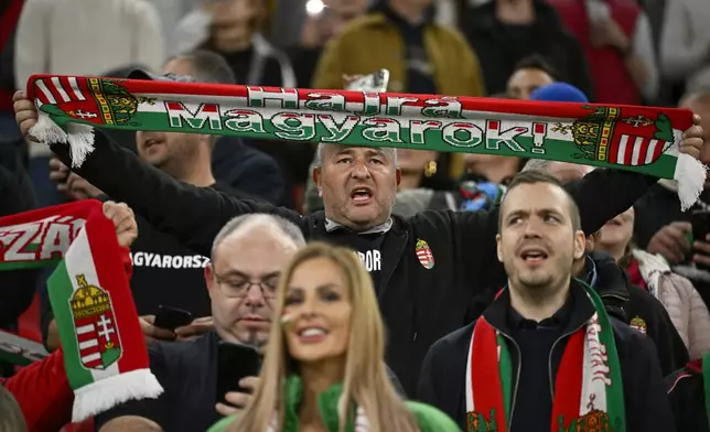 A Hungary fan holds up his scarf on the stands during the Nations League soccer match between Hungary and the Netherlands at the Puskas Arena in Budapest, Friday, Oct. 11, 2024. (AP Photo/Denes Erdos)