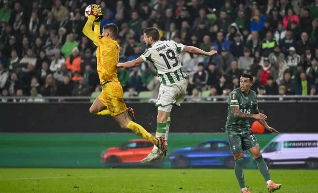 Tottenham's goalkeeper Guglielmo Vicario makes a save during the Europa League soccer match between Ferencvaros and Tottenham Hotspur in Budapest, Hungary, Thursday, Oct. 3, 2024. (AP Photo/Denes Erdos)