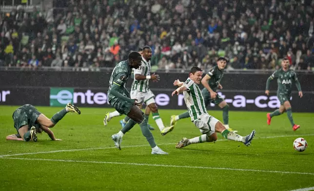 Tottenham's Pape Matar Sarr, centre left, scores his side's opening goal during the Europa League soccer match between Ferencvaros and Tottenham Hotspur in Budapest, Hungary, Thursday, Oct. 3, 2024. (AP Photo/Denes Erdos)