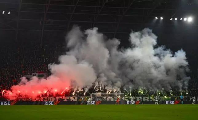 Supporters fire flares during the Europa League soccer match between Ferencvaros and Tottenham Hotspur in Budapest, Hungary, Thursday, Oct. 3, 2024. (AP Photo/Denes Erdos)