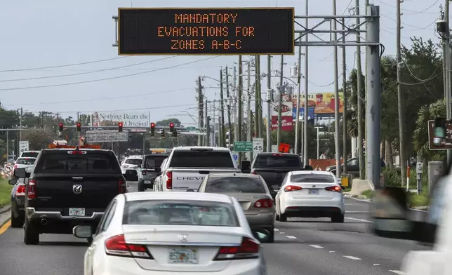 Highway signage announces the impending arrival of Hurricane Milton and the evacuations zones on Tuesday, Oct. 8, 2024, in Port Richey, Fla. (AP Photo/Mike Carlson)