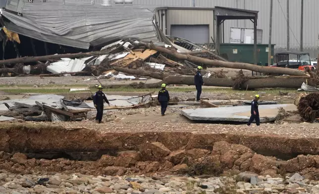 Personnel from Urban Search and Rescue Utah Task Force 1 work in the aftermath of Hurricane Helene Friday, Oct. 4, 2024, in Erwin, Tenn. (AP Photo/Jeff Roberson)