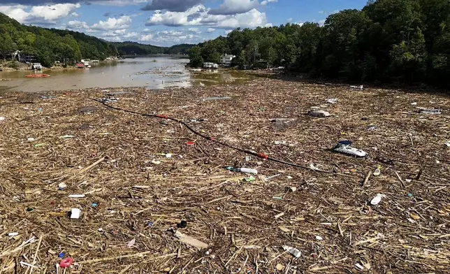 Debris is strewn on the lake in the aftermath of Hurricane Helene, Wednesday, Oct. 2, 2024, in Lake Lure, N.C. (AP Photo/Mike Stewart)
