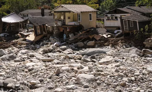 Homes are seen in the aftermath of Hurricane Helene, Wednesday, Oct. 2, 2024, in Chimney Rock Village, N.C. (AP Photo/Mike Stewart)