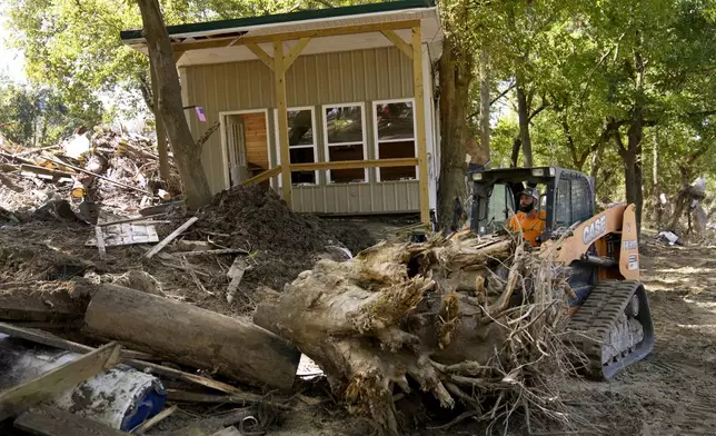 Debris left in the aftermath of Hurricane Helene is cleared Saturday, Oct. 5, 2024, in Del Rio, Tenn. (AP Photo/Jeff Roberson)