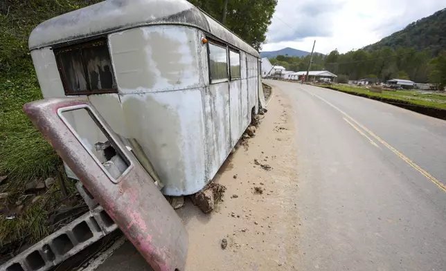 A trailer moved by floodwater sits on the side of a road in the aftermath of Hurricane Helene, Thursday, Oct. 3, 2024, in Pensacola, N.C. (AP Photo/Mike Stewart)